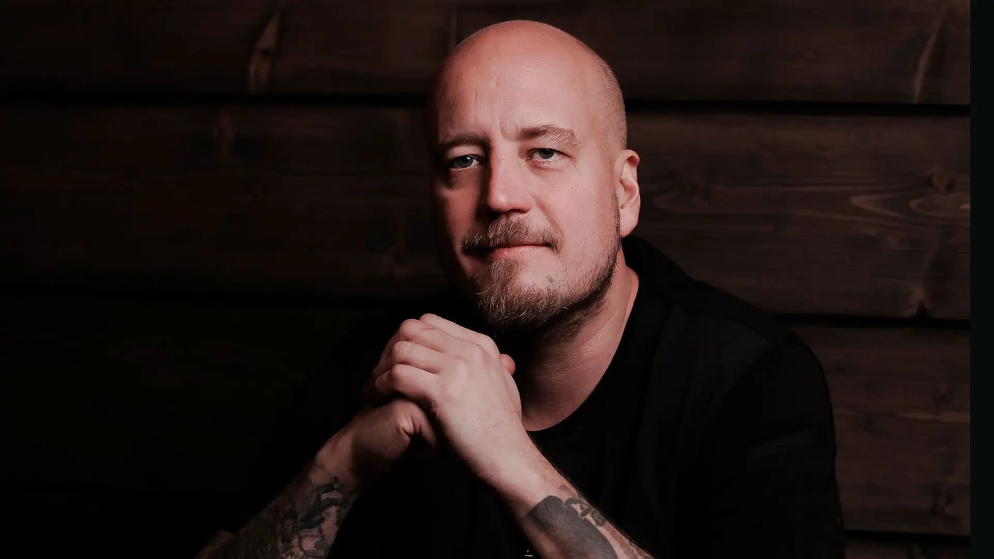 Tumma kuva, jossa Miilu Resortin Keittiömestari Alex Räsänen katsoo kuvaajaa. 